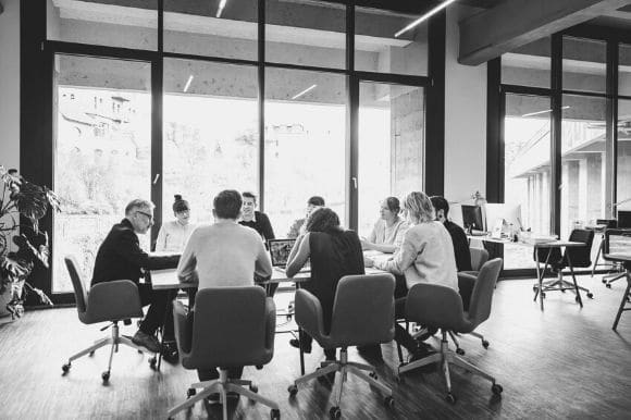 Employees meet in a conference room.