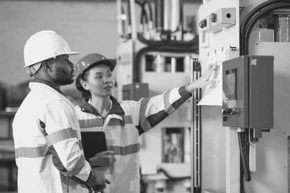 CNC operator working with her colleague.