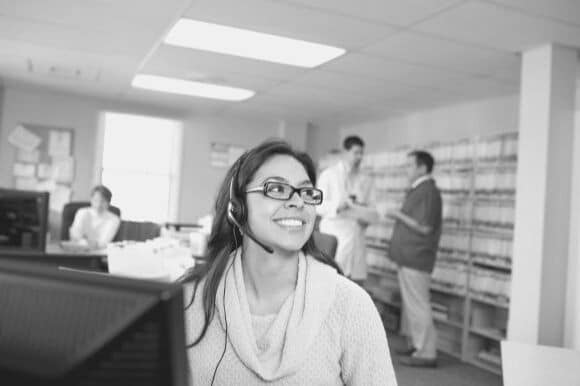 A medical receptionist works in an office.