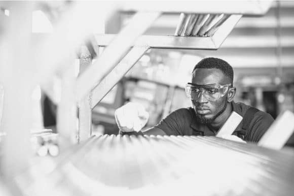 Quality assurance manager inspecting a product before it gets packaged and delivered.