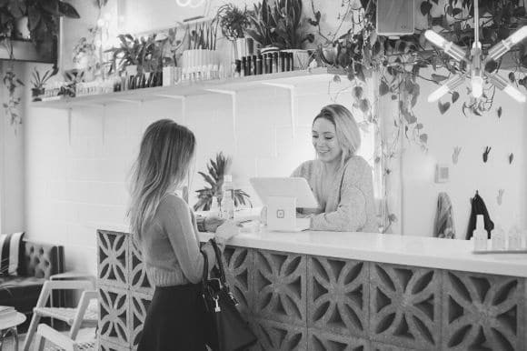 A receptionist greets clients.