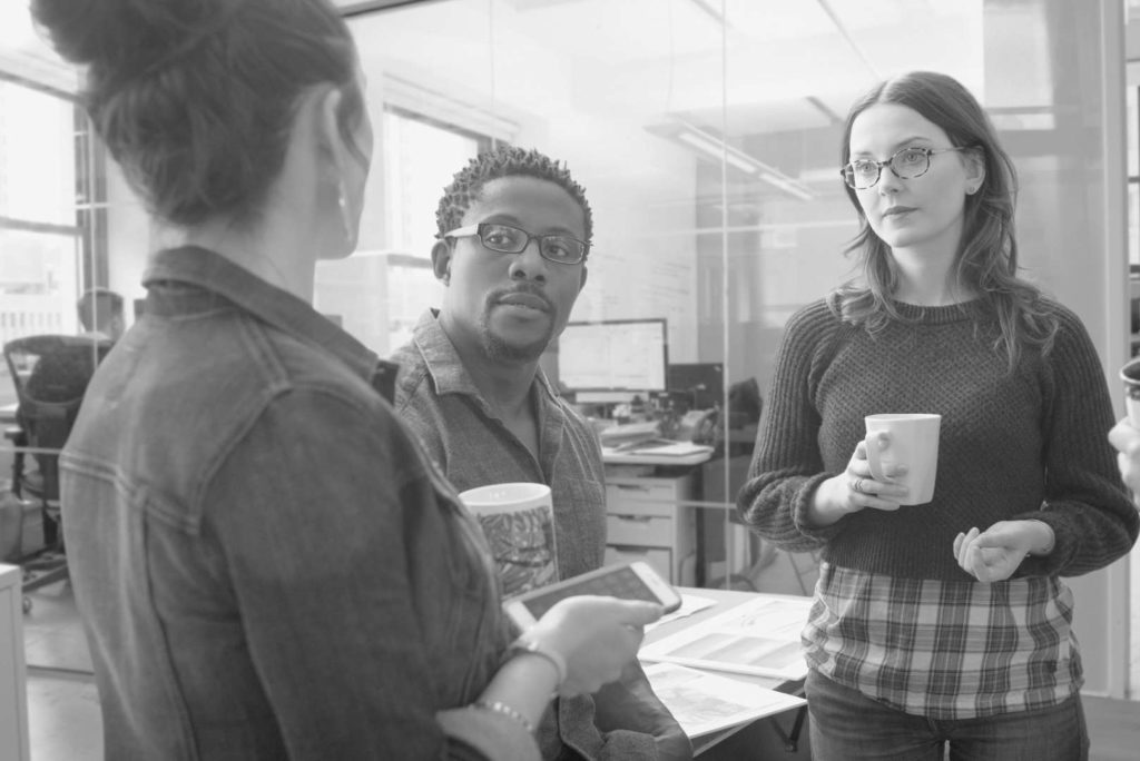 Employees participating in workplace gossip.