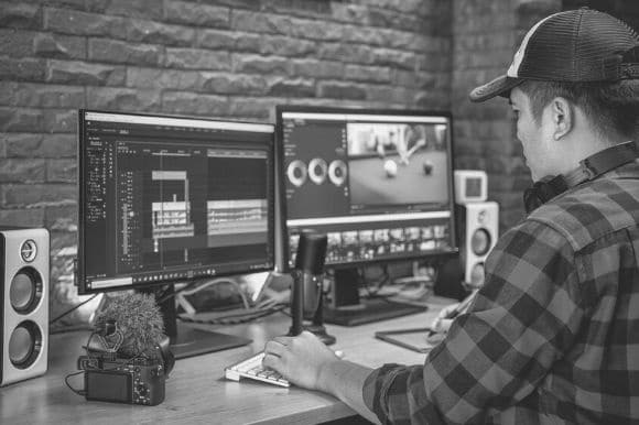 A worker editing video as part of his company's video marketing efforts.