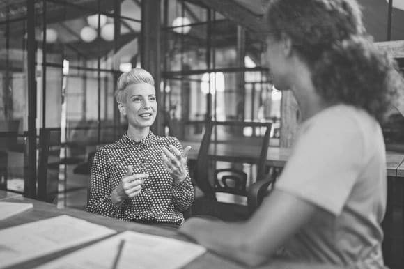 An event coordinator speaks with a client.