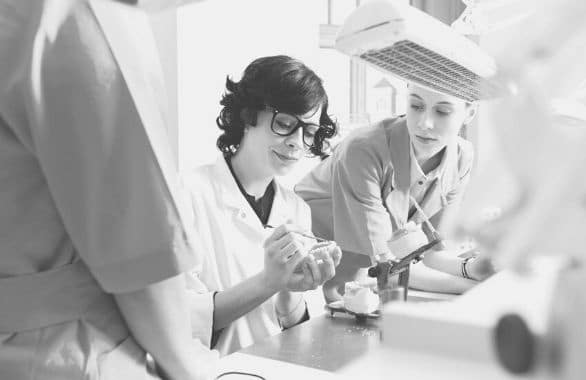 Dental lab technician working with a dental mold in office