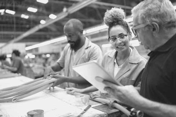 Electrical engineering manager talking with employees at work