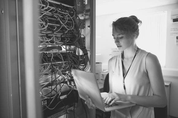 Information security technician checking equipment server