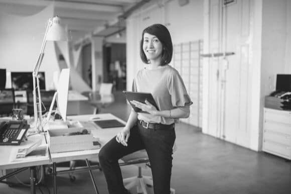 Information systems manager standing at office desk