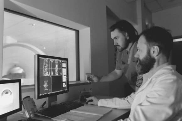 Radiology supervisor working with one of his employees.