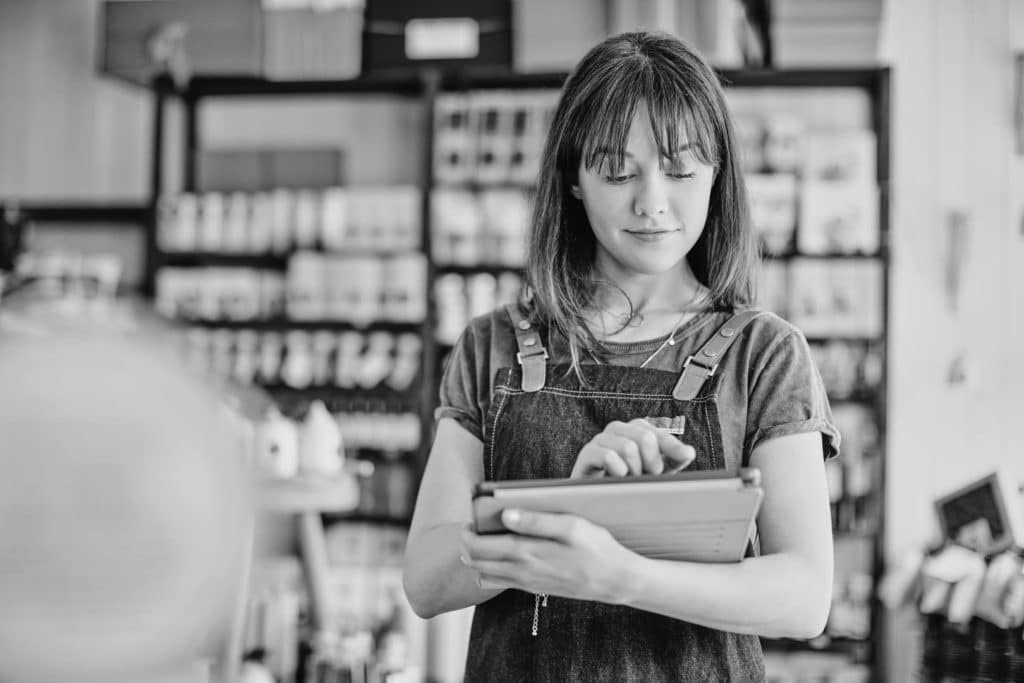 A retail store associate helps a customer.