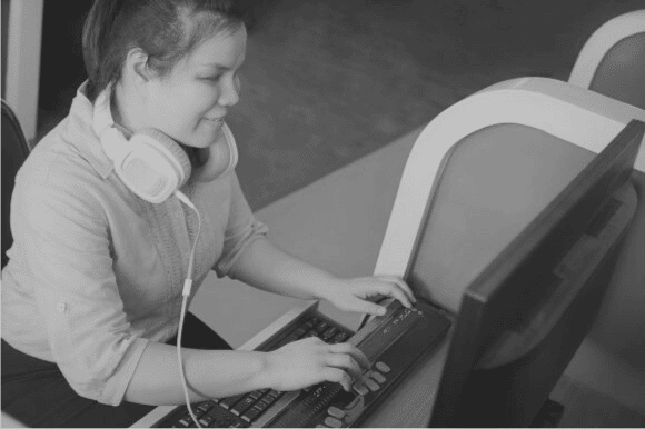 Visually impaired woman using screen reader accessibility system on a computer