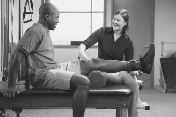 A physical therapist works with her client.