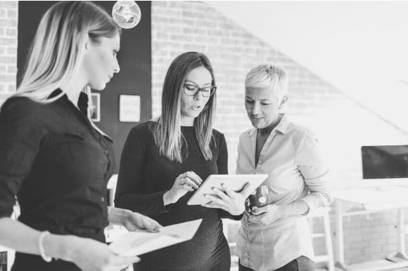 Marketing operations manager meeting with two of her colleagues to discuss a marketing campaign.