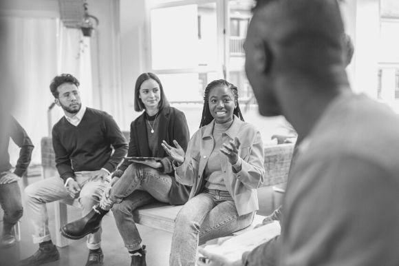 A manager leads and internship program meeting.