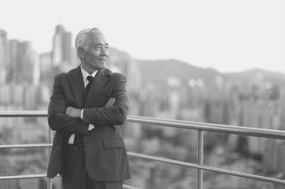 A city manager, standing on the balcony overlooking the downtown.