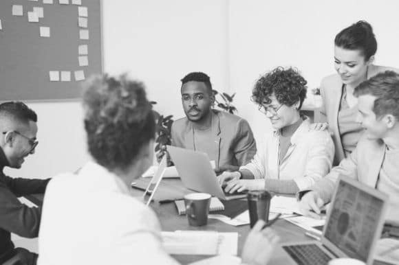 A team of happy employees, working together after a much-appreciate pay raise.