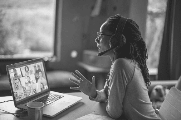 Woman working from home, on a video call with colleagues, illustrating how a flexible workforce can be arranged.