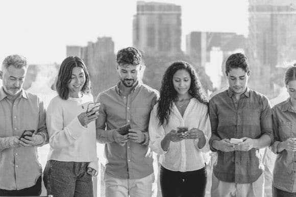 Coworkers, following the company's social media policy for recruitment, reviewing candidates on their social apps.