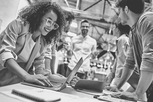 Happy coworkers in an office that values diversity and innovation.