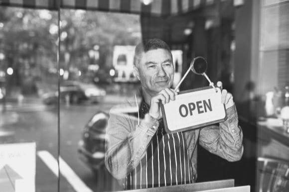 Business owner opening store and keeping business recession proof