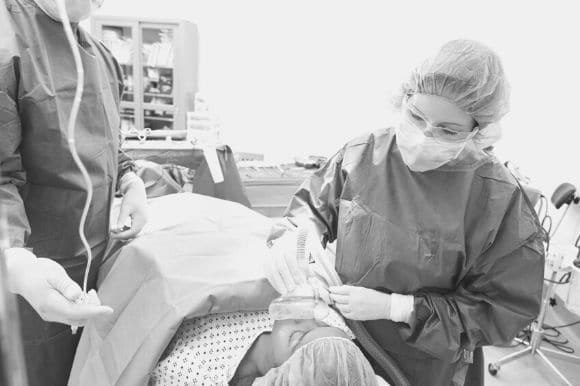 Anesthetist helping a patient before surgery.