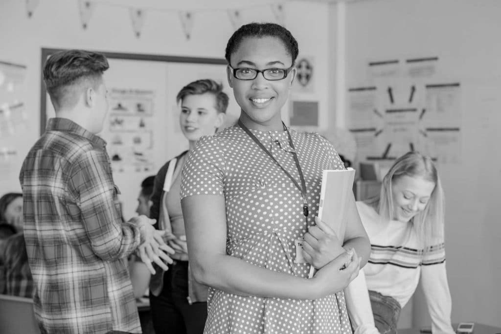 A middle school teacher in a classroom.