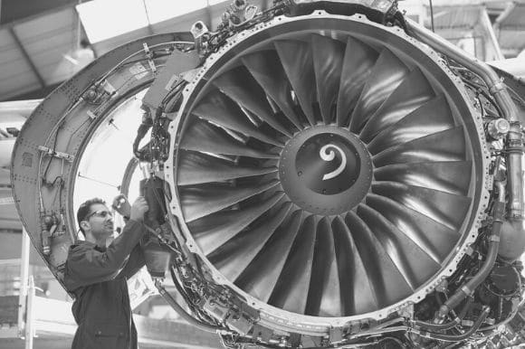 Aerospace engineer inspecting a newly manufactured jet engine.