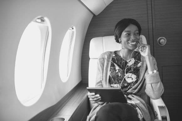 An asset manager, sitting on a client's private airplane while reviewing their portfolio.
