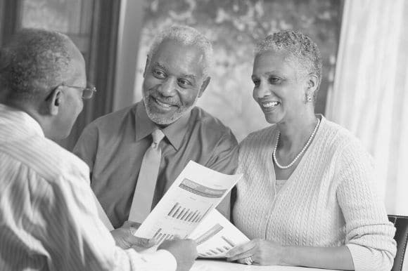 Financial advisor talking with clients in an office