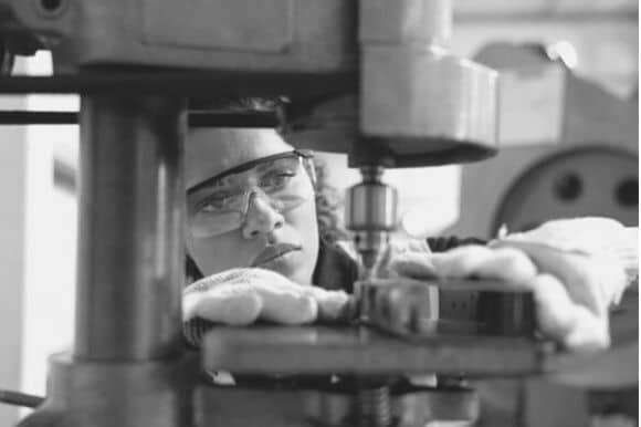 Machinist using her equipment at work