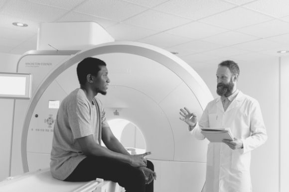 Radiation therapist discussing treatment options with his patient.