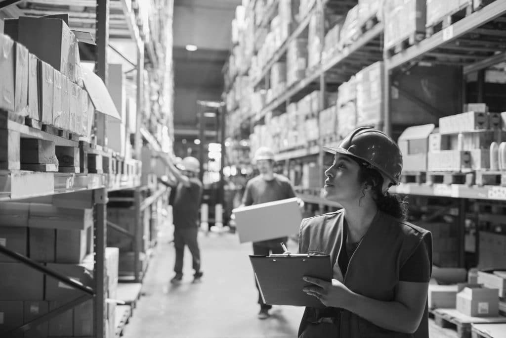 A woman works in a warehouse.