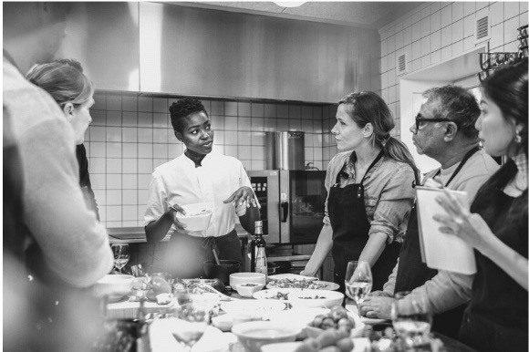 Chef meeting with her kitchen staff
