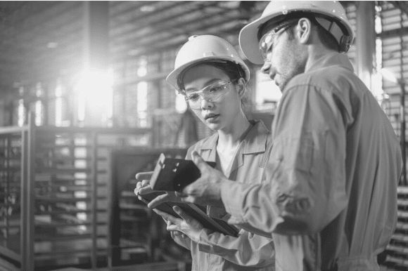 Construction worker discussing the integrity of a part with his colleague.