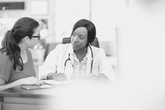 Director of nursing meeting with a nurse colleague.