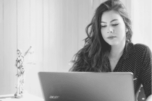 Lawyer reviewing her case or conducting research on a laptop computer.