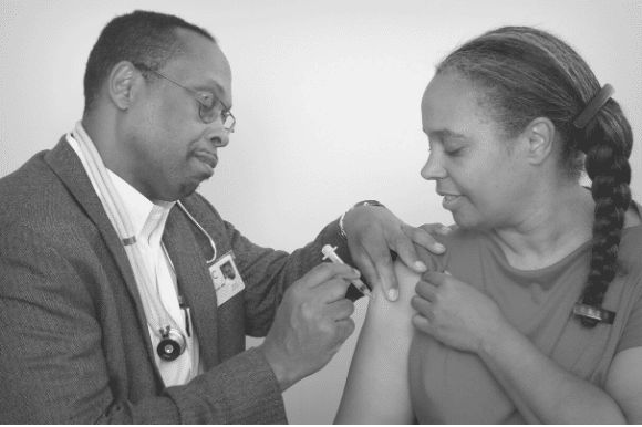 Physician vaccinating a patient.