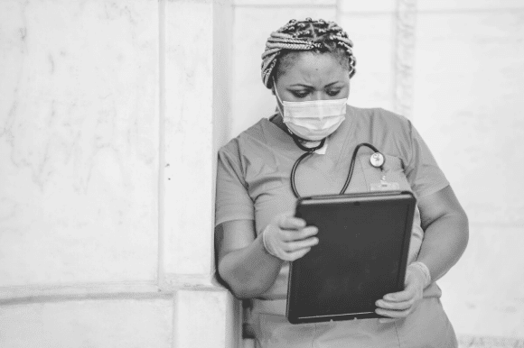 Medical director reviewing files on a tablet computer.