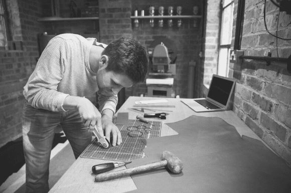 Man working on a product for his home-based microbusiness.