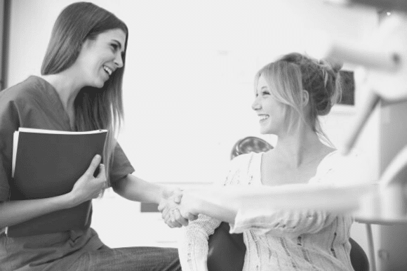 Women discussing small business employee benefits in an office