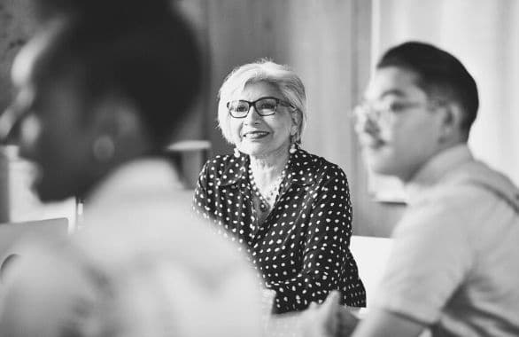 An older employee attending a company meeting.