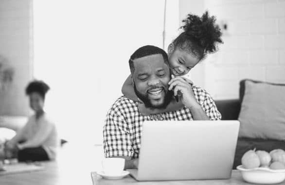 Professional at his kitchen table, working from home with kids.