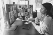 Woman sitting at her desk at home, engaging in cross team collaboration via video call.