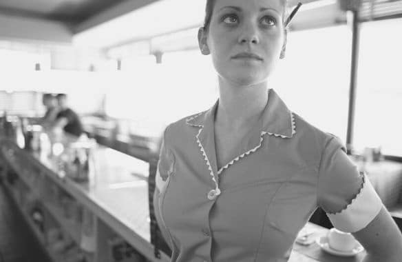 A waitress at a diner takes a moment to catch her breath.