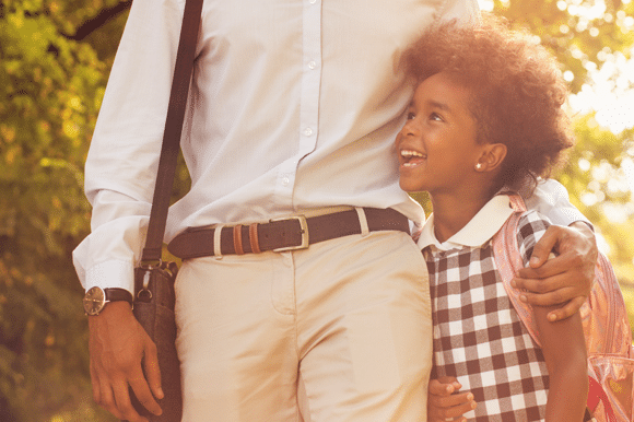 father and daughter walking to school