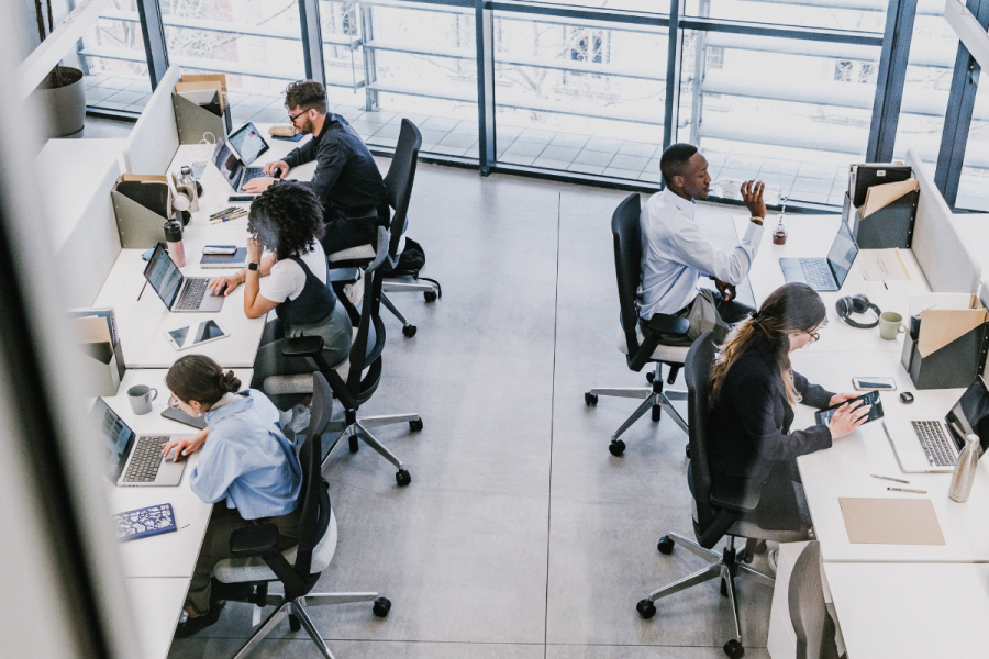 birds eye view of workers in an office sitting at their desks with computers
