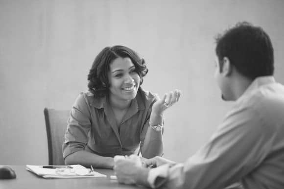 A manager asking her employee stay interview questions during an annual check-in.