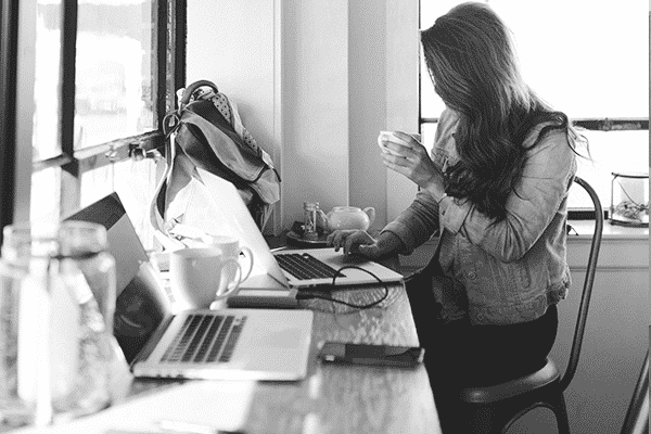 A woman sits at the table in an office