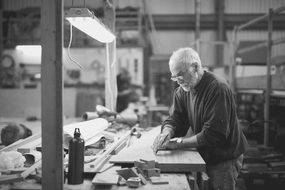 Older male worker in a shop.