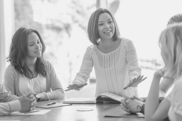 Finance director discussing financial initiatives with her colleagues.